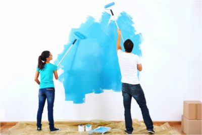 Couple using paint roller